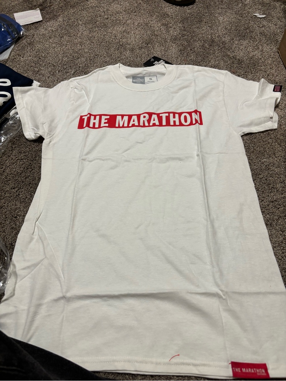 The Marathon White Tee with Red Chest Logo